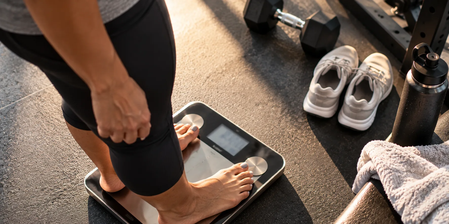 Body Fat Percentage Testing in Miami for Smarter Weight Loss Program at Brickell Studio Person stepping onto body composition scale for body fat percentage testing as part of Miami weight loss program